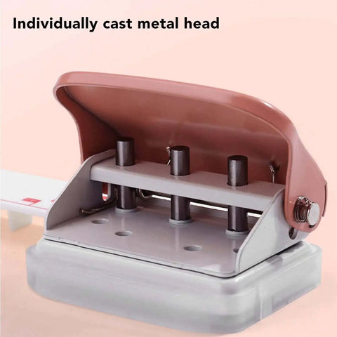 Close-up of pink handheld 3 hole paper punch for binders with metal head, punches up to five pages at once, 5.5mm holes, 19mm spacing