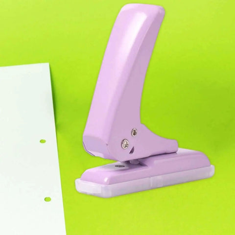 Purple Pro Grade 40 Sheet Single Hole Punch with Non Slip Base 5.5mm Hole Adjustable Punch Position on green background