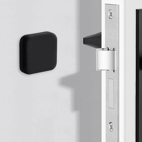 Black silicone door stopper wall protector installed in room; Protect walls and furniture from dents and scratches with a silicone door stopper wall protector.