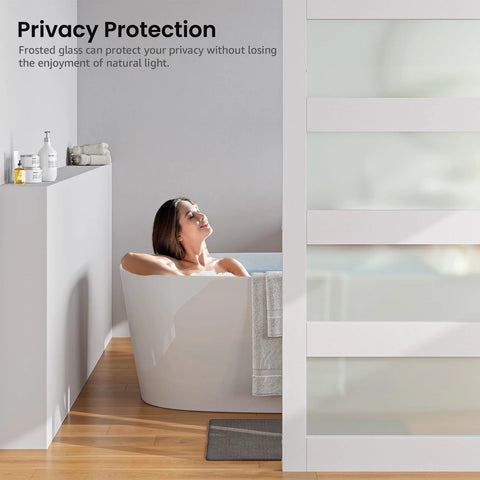 Person relaxing behind 36 Inch By 84 Inch Glass Barn Door Slab In White MDF With Frosted Glass PVC Surface Includes Six Point Six Feet Hardware Kit Door Handle And Floor Guide DIY Friendly And No Fuss Ready To Install