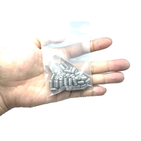 Hand holding a bag with 50-Piece Set Screws 1/4-20 By 5/16 Inch 304 Stainless Steel Hex Socket Grub Screws