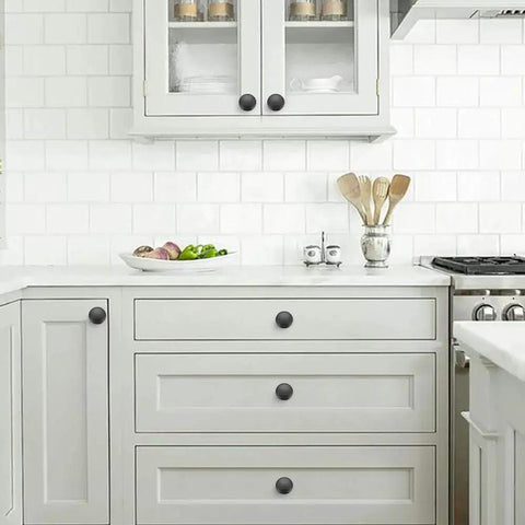 Matte Black Zinc Cabinet Knob And Drawer Pull Set installed in a modern kitchen, showcasing smooth finish and Euro style.