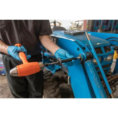 Heavy-Duty Grease Fitting Cleaner For Hardened Clogs With Impact Tool being used on blue machinery