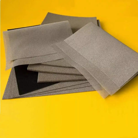 All Round Conductive Foam Metal Sponge With Adhesive for EMI Shielding, Lab Grade, 200x300mm, shown in layered sheets on a yellow background.