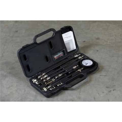 Engine Compression Test Kit With 2.75in Gauge And Quick Disconnect Adapters in a black carrying case on concrete surface