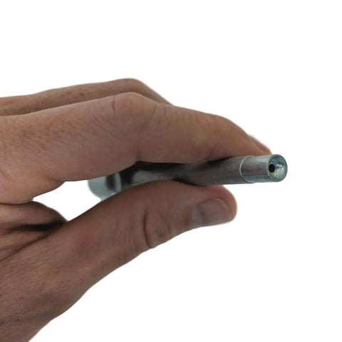 Close-up of a hand holding Recessed Fitting Adapter With Six Inch Reach For Deeply Recessed Grease Fittings, Cup Shaped End For Clean Seating, Quick Connect Locking Fit With Any Grease Coupler, Heavy Duty Pro Grade Tool By LockNLube.