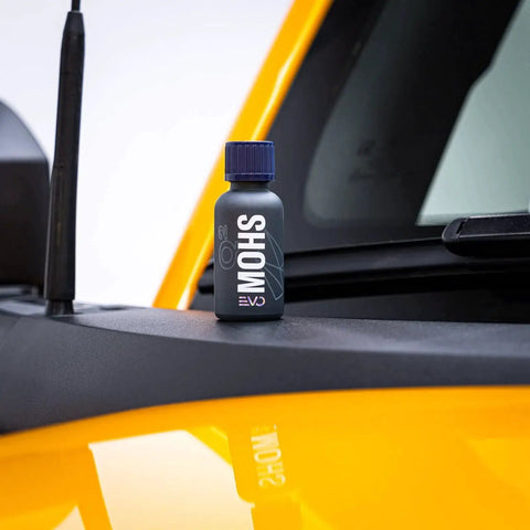 Bottle of Gyeon Mohs Ceramic Coating Kit For Cars DIY Deep Gloss And 3 Year Protection on a car hood