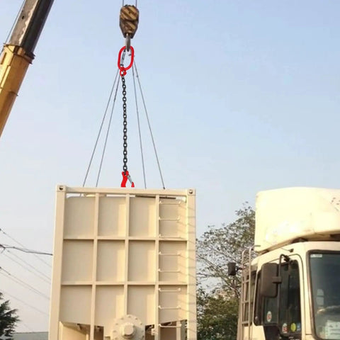 Front view of a Baluue chain sling with red hooks on both ends hoisting a large beige cargo container.