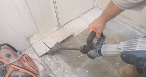 Person using SDS Max Floor Scraper Heavy Duty Beast Pro Tool With Two Point Five Millimeter Blade for fast concrete demo and floor prep.