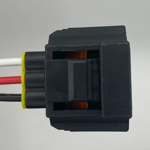 Side view of 3-pin black brake fluid level sensor connector with red, white, and black wires and yellow seal