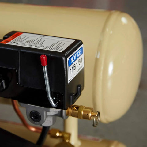 Brass 1/4'' NPT safety valve installed on air compressor pressure relief line