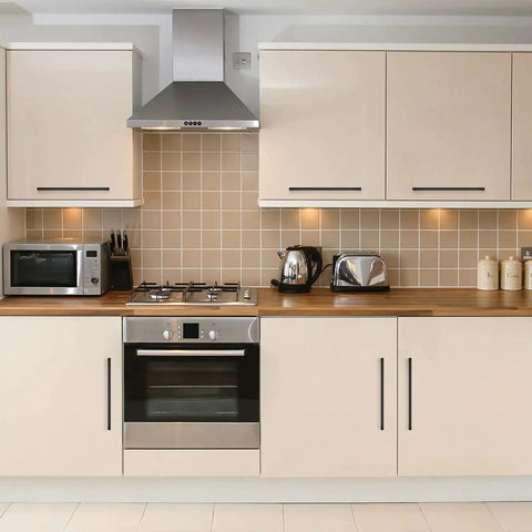 Modern kitchen with 12.6 Inch Square Cabinet Handles Matte Black Pulls on cream cupboards, featuring stainless appliances and wood countertop.