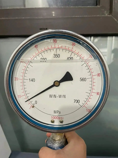 80 KSI High Pressure Waterjet Gauge and Spare Parts Kit for A-10420 Cutting Machine Flow KMT Waterjet Compatible Durable Silver Components for Fast Maintenance and Long Service Life showing a close-up view of a pressure gauge dial with a hand holding it, displaying pressure measurements in both MPa and psi.