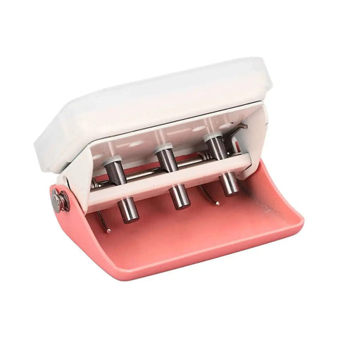 Three Hole Punch Handheld Paper Puncher With Five Sheet Capacity And Alignment Posts for B5 A5 A4 A6 A7, pink metal, angled view
