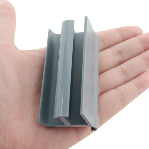 Grey PVC Sliding Shower Door Bottom Track For 7/16 Inch And 5/16 Inch Glass Thicknesses, Durable Moisture-Resistant Rail With Grey Finish, shown on hand.