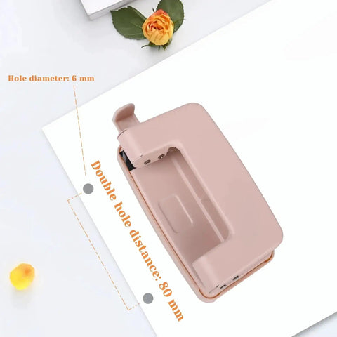 Pink Two Hole Punch With Ruler One Quarter Inch Punch for file folders and looseleaf, metal manual low force, top view