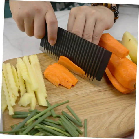 Person using Wavy Chopper Knife Crinkle Cutter For Chips And Veggies Stainless Steel Mandoline Slicer to cut carrots on a wooden board