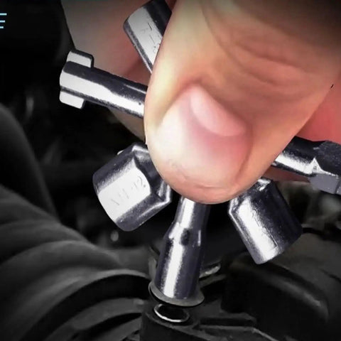 Close-up of a hand using the All In One 10 In 1 Carbon Steel Portable Screwdriver And Wrench Kit on a control cabinet.