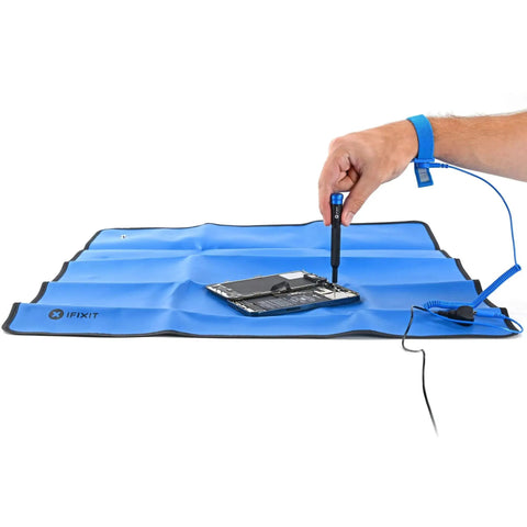 Portable Anti Static Mat With ESD Pad And Wrist Strap Grounding Cord For Electronics Repair From iFixit in use on blue surface