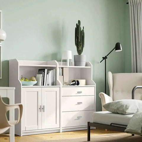 Modern living room with white cabinet, drawers, and comfortable chair, featuring a cactus plant and books.
