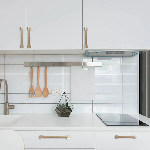 Modern kitchen with Champagne Bronze Cabinet Handles Set of 10, 5 Inch (128mm) Drawer Pulls installed on white cabinets.