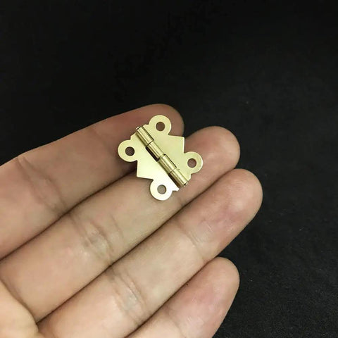 Antique Brass Mini Butterfly Hinges With 200 Screws For Wooden Boxes And Jewelry Chests 50 Pieces 20x17mm shown on hand