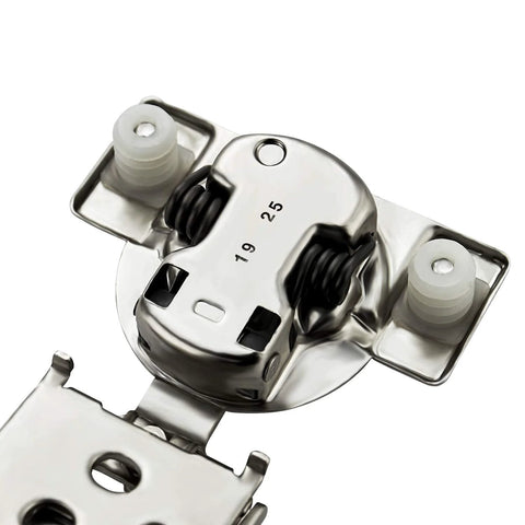 Concealed satin-nickel cabinet hinge with soft-close dampers; close-up of mounting plate and springs
