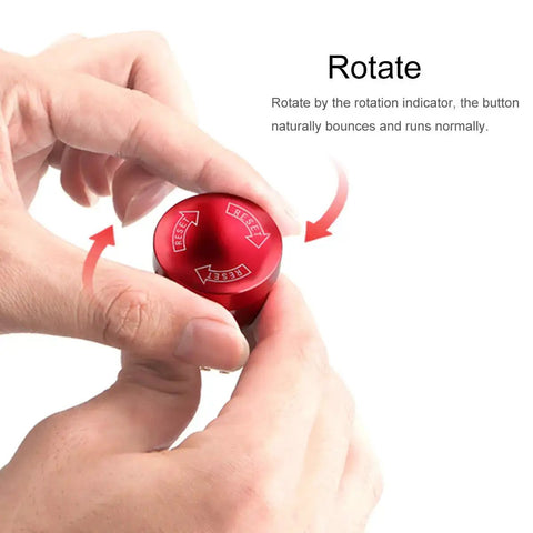 Rotating hand on Metal Emergency Stop Push Switch With Self Locking Rotary Mushroom Cap showing directional arrows.