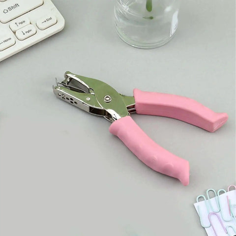 6mm Handheld Single Hole Punch For Paper With Durable Metal Body And Rubber Grip Handle on desk with office supplies