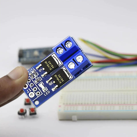 12 Pack High Power MOSFET Trigger Switch Drive Module 5V-36V DC PWM Controller held in hand with wires and breadboard in background