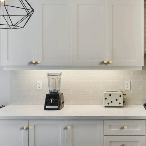 Modern kitchen view with 10 Pack Matte Black And Gold Knurled Cabinet Knobs For Kitchen Cabinets And Dressers Zinc Drawer Knobs installed on white cabinets