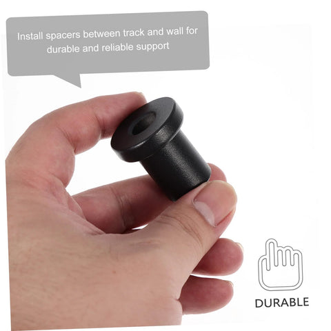 Hand holding a black round 4 Pack Barn Door Track Spacers For Sliding Doors Heavy Duty Iron Connector Assemblies