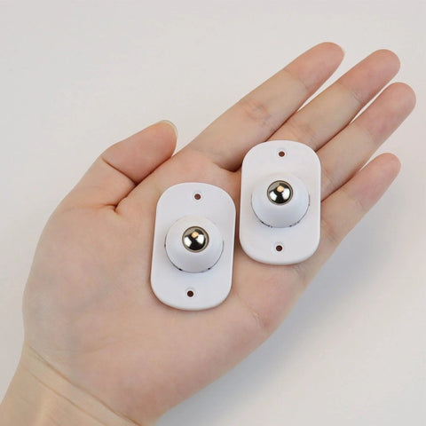Hand holding 8 Pack Self Adhesive 360 Degree Swivel Caster Wheels for Appliances and Furniture White