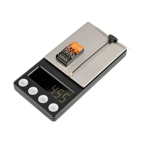 ExpressLRS Micro Receiver With Five PWM Outputs Failsafe And IPEX MHF T Antenna on a scale showing weight, top view