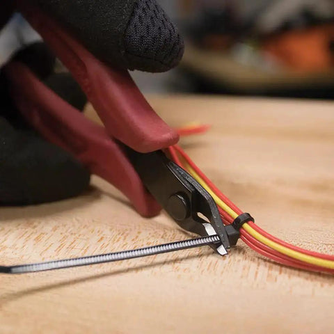 Ultra Slim 5-Inch Diagonal Flush Cutters snipping micro wire and zip ties in tight space, showing precise flat cut.