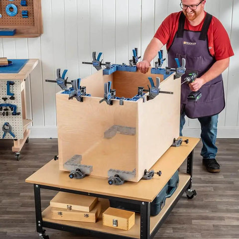 Clamp It Corner Woodworking Jig For 90 Degree Right Angle Cabinet Assembly in use on wooden cabinet, hands-free positioning.