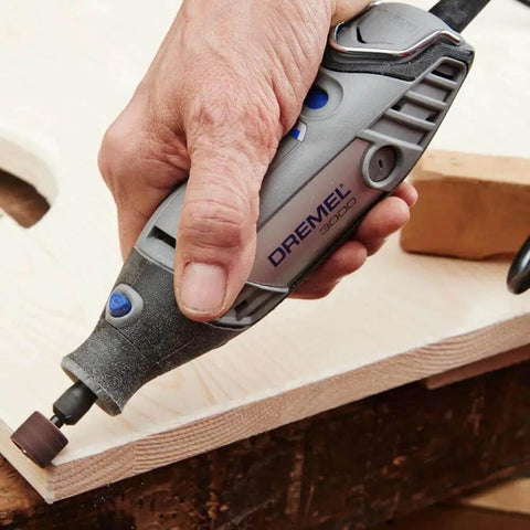 Close-up of Dremel tool with Beast Half Inch Coarse Sander Bands Set For Rotary Tools 60 Grit 6 Pack Dremel Compatible sanding wood surface