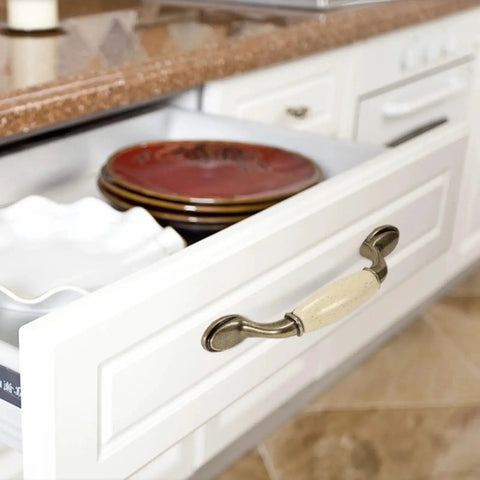 Open kitchen drawer showing Eight Piece Ceramic Drawer Handles Set In Chinese Style With Vintage Antique Design for cabinets.