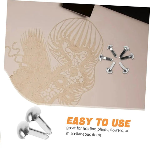 100 Pcs Iron Brads For Paper Crafting And Puppet Making Kit Double Leg Fasteners shown alongside cut paper artwork