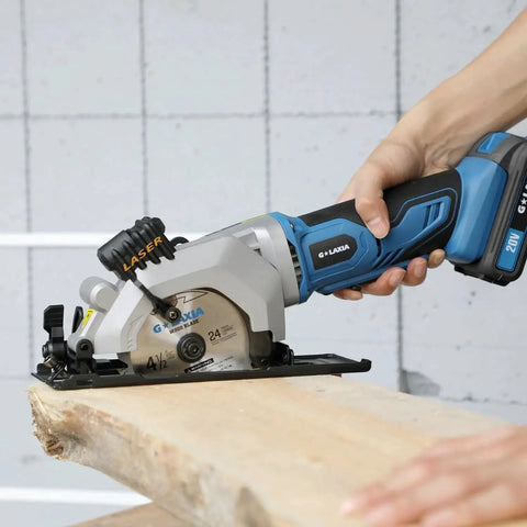 Person using Pro Grade Mini Cordless Circular Saw With Laser Guide And Rip Guide For Precise DIY Cuts, 4-1/2 Inch Blade, 3400 RPM No-Load, Includes 24T And 60T High Quality Blades, Max Cutting Depth 1-11/16 At 90 Degrees And 1-1/8 At 45 Degrees, Blue on wood