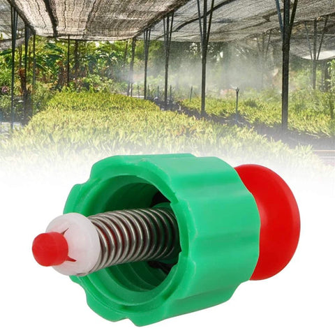 Green plastic pressure relief valve with red plunger and metal spring for garden backpack sprayer.