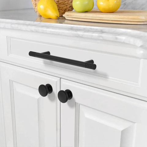 Installed Matte Black Solid Cabinet Pulls 5 Inch 128mm Hole Centers on white kitchen cabinet drawer.