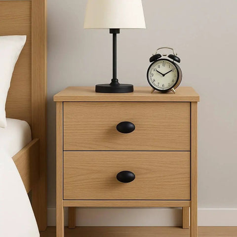 Wooden nightstand with Oval Matte Black Cabinet Knobs 10 Pack For Kitchen And Furniture By EAXINTA Modern Single Hole Hardware installed.