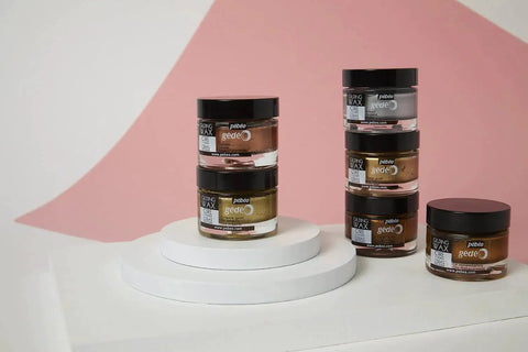 Stack of Gilding Wax King Gold Metallic Paste jars on display with pink and white background, 5.6 oz size