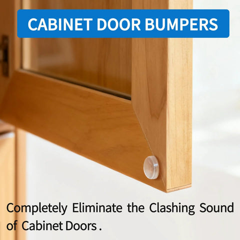 Cabinet door bumper on a light wood cabinet; single white plastic round bumper at lower corner.