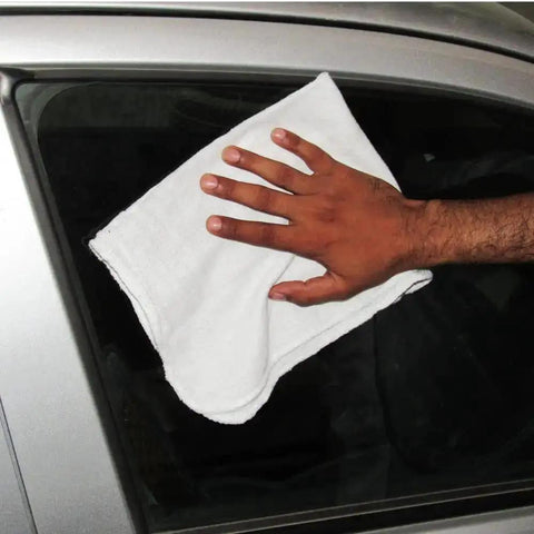 Hand using white cotton towel on car window, from Pack Of 50 Cotton Shop Towels 13 By 14 Inches Absorbent Reusable Cleaning Rags For Auto Shop Garage Home Use Multipurpose White Towels Great For Automotive Detailing Industrial Cleanups And General Cleaning