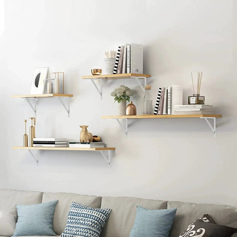 Wall-mounted shelves on living room wall supported by Heavy Duty 12-Inch By 8-Inch Shelf Brackets With 600 Lb Capacity 10 Pack White Metal L Supports.
