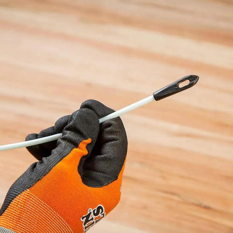 Gloved hand holding fish tape with eyelet from the Non Conductive Fish Tape Repair Kit For Fiberglass Tapes Made In USA