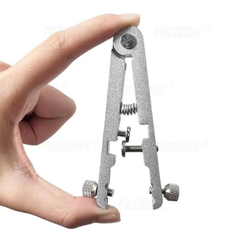 Hand holding metal Pro Grade Watch Spring Bar Plier Tool Kit With Tweezers And 10 Replacement Pins For Link Removal And Band Repair