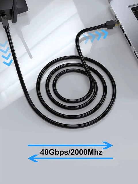 Coiled Beefy Cat8 Shielded Ethernet Cable 50 Ft Indoor Outdoor Direct Burial 26AWG SFTP Patch Cord connected to a laptop
